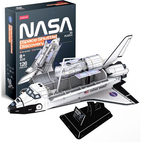 Pudełko z puzzlami 3D przedstawia napis "NASA {Space Shuttle} Discovery" oraz informacje: "No gluing", "No tools", "8+ Age", "126 Pieces". Obok znajduje się złożony model wahadłowca z widocznym napisem "United States" i logo NASA na skrzydle.