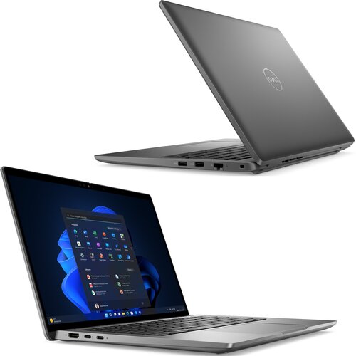 Na zdjęciu widoczny jest laptop z otwartym ekranem, na którym wyświetlany jest interfejs systemu Windows 11. Obudowa laptopa jest w kolorze szarym, a na pokrywie znajduje się logo "Dell".