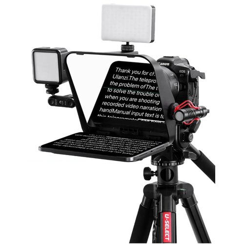 Na zdjęciu znajduje się teleprompter zamontowany na statywie, z aparatem fotograficznym i dwoma lampami LED. Na ekranie telepromptera widoczny jest tekst: "Thank you for choosing Ulanzi. The teleprompter is designed to solve the problem of The trouble of 