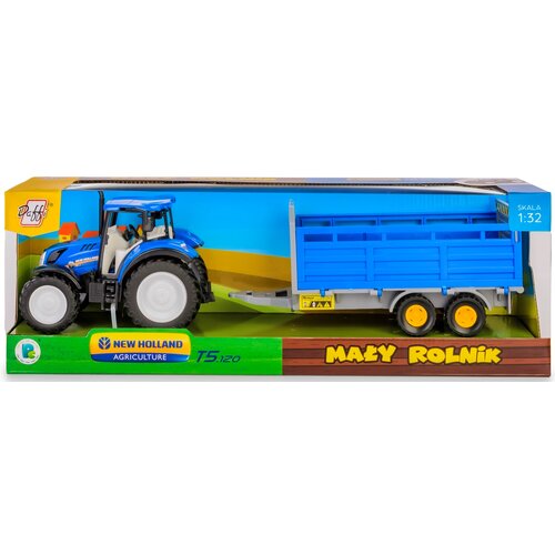 Na zdjęciu znajduje się zabawkowy traktor w kolorze niebieskim z przyczepą do transportu inwentarza, umieszczony w opakowaniu z napisem "Mały Rolnik" oraz "New Holland Agriculture T5.120". W prawym górnym rogu opakowania widnieje napis "Skala 1:32".