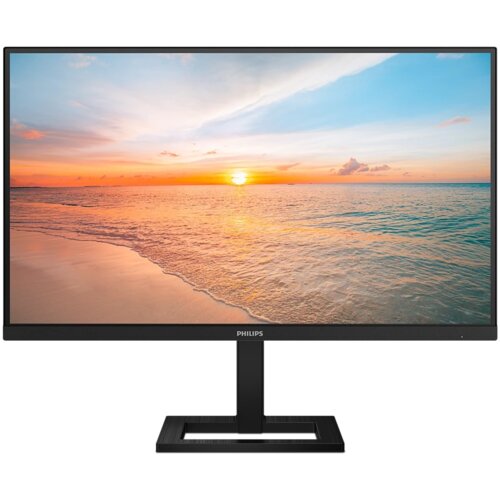 Monitor z czarną ramką i podstawą, wyświetlający obraz zachodu słońca nad morzem. Na dolnej ramce widoczne jest logo "PHILIPS".