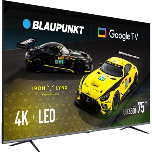 Telewizor z wyświetlonym obrazem dwóch samochodów wyścigowych na torze, z logo "BLAUPUNKT" i "Google TV" u góry. Na ekranie widoczne są napisy: "IRON LYNX MOTORSPORT LAB", "4K", "LED", "UGC5500", oraz "75"".
