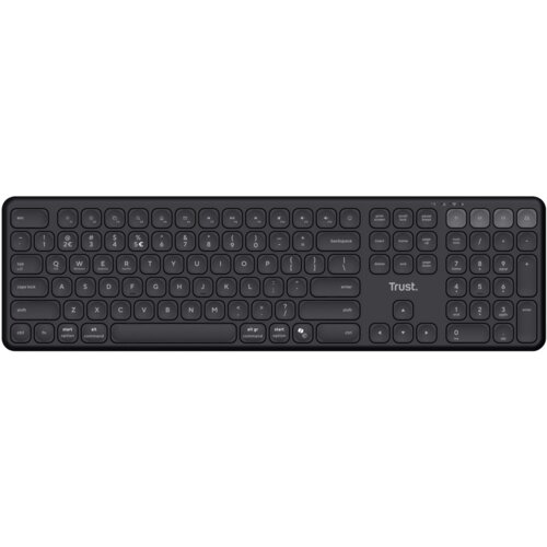 Na zdjęciu znajduje się czarna klawiatura z układem QWERTY, na której widoczne są klawisze funkcyjne, numeryczne oraz literowe. Na klawiaturze znajduje się logo "Trust".