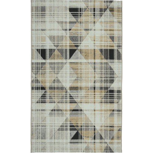 Dywan wewnętrzny o wymiarach 80 x 150 cm w kolorze żółtym, z geometrycznym wzorem składającym się z kratek i trójkątów w odcieniach czerni, szarości i beżu. Wzór tworzy efekt przecinających się linii i kształtów.