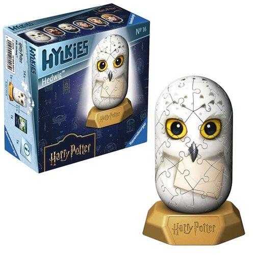 Pudełko z puzzlami 3D przedstawia sowę z serii Harry Potter, z napisem "Hylkies" oraz "Hedwig" na niebieskim tle. Obok pudełka znajduje się złożony model sowy z dużymi żółtymi oczami, umieszczony na podstawce z napisem "Harry Potter".