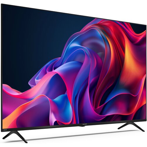 Telewizor SHARP 50GK4745E 50" LED 4K prezentuje na ekranie dynamiczną grafikę w intensywnych kolorach, takich jak fiolet, róż i pomarańcz. Na dolnej ramce widoczne są napisy "AQUOS" oraz "SHARP".