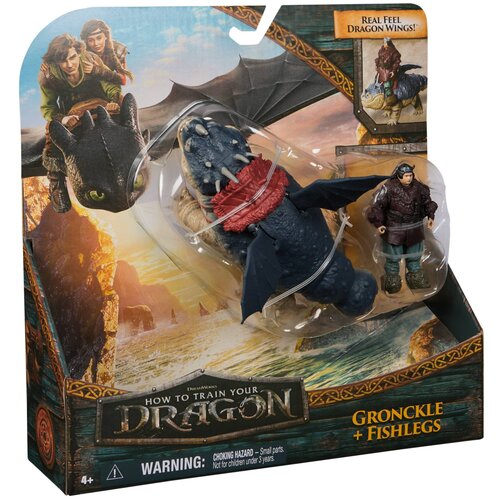Opakowanie zestawu figurek z serii "How to Train Your Dragon" zawiera figurki smoka i wikinga, z widocznym napisem "Gronckle + Fishlegs" oraz ostrzeżeniem "WARNING: CHOKING HAZARD - Small parts. Not for children under 3 years." Na opakowaniu znajduje się 