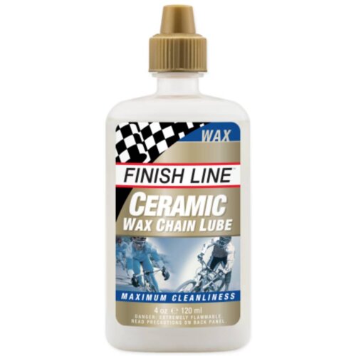 Biała butelka z brązowym korkiem zawiera produkt "FINISH LINE Ceramic Wax Chain Lube" o pojemności 120 ml. Na etykiecie widnieje napis "MAXIMUM CLEANLINESS" oraz zdjęcie rowerzystów.
