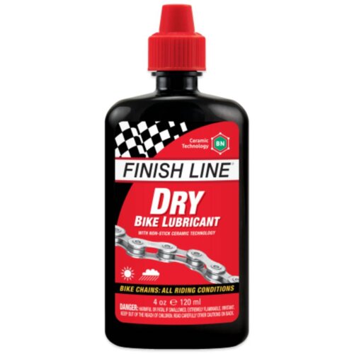 Czarno-czerwona butelka z czerwonym korkiem, na której widnieje napis "FINISH LINE DRY BIKE LUBRICANT" oraz grafika łańcucha rowerowego. Na etykiecie znajdują się również informacje: "Ceramic Technology", "BN", "4 oz e 120 ml" oraz ostrzeżenie dotyczące b