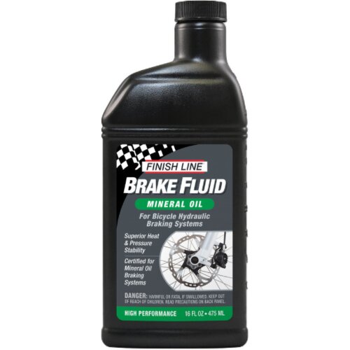 Czarna butelka z etykietą zawierającą tekst: "FINISH LINE Brake Fluid Mineral Oil For Bicycle Hydraulic Braking Systems Superior Heat & Pressure Stability Certified for Mineral Oil Braking Systems". Na dole etykiety znajduje się ostrzeżenie: "DANGER: HARM