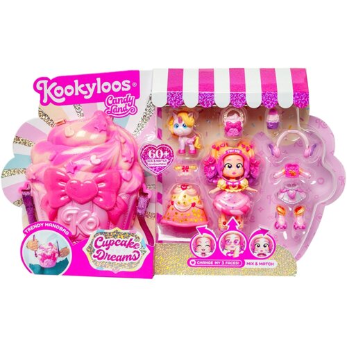 Opakowanie produktu "Lalka MAGIC BOX KookyLoos Candy Land Cupcake Dreams PKLSP104IN230" przedstawia różową torebkę w kształcie babeczki oraz lalkę z wymiennymi twarzami i akcesoriami. Na opakowaniu widnieją napisy: "Kookyloos", "Candy Land", "Cupcake Drea