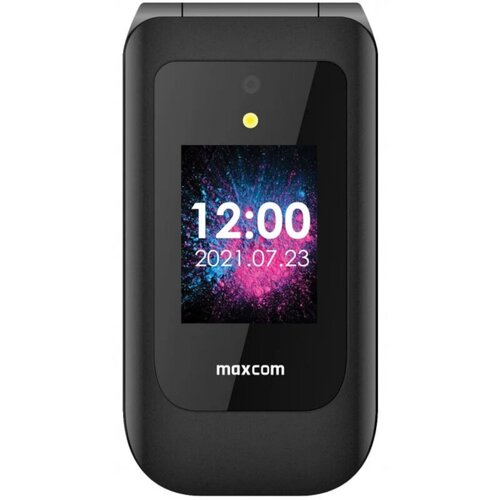 Czarny telefon z klapką marki maxcom, na którego zewnętrznym wyświetlaczu widoczna jest godzina 12:00 oraz data 2021.07.23 na tle kolorowego wzoru. Powyżej ekranu znajduje się mała kamera i dioda.