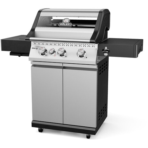 Srebrny grill gazowy z czterema pokrętłami na panelu przednim, posiada szklane okienko w pokrywie oraz boczne półki. Na pokrywie widoczne jest logo "KOLER".