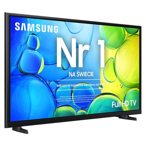 Telewizor z kolorowym ekranem wyświetla napis: "SAMSUNG Nr 1 NA ŚWIECIE, Najczęściej kupowane telewizory od 14 lat, Full HD TV". W tle widoczne są abstrakcyjne, kolorowe kształty w odcieniach niebieskiego, zielonego i żółtego.