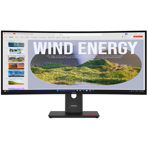 Monitor wyświetla prezentację z dużym napisem "WIND ENERGY" oraz krajobrazem z turbinami wiatrowymi na zielonych wzgórzach. Na dolnej ramce monitora widoczne jest logo "Lenovo".