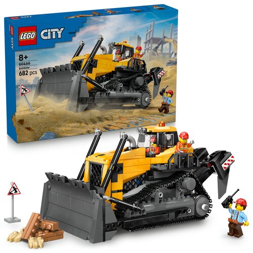 Na zdjęciu znajduje się zestaw klocków LEGO City z modelem żółtego buldożera, oznaczony numerem 60466, składający się z 682 elementów. W tle widoczne jest opakowanie z grafiką przedstawiającą buldożer na placu budowy oraz figurki pracowników budowlanych.