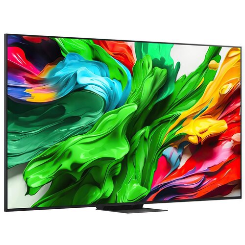 Na zdjęciu widoczny jest telewizor z dużym, kolorowym wyświetlaczem, na którym prezentowane są abstrakcyjne wzory w intensywnych barwach zieleni, niebieskiego, czerwieni i żółci. Telewizor ma cienką ramkę i stoi na prostokątnej podstawie.