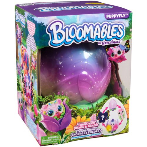 Pudełko z zabawką "Bloomables by Hatchimals" zawiera dużą, fioletową kulę z motywem kwiatowym oraz grafikę przedstawiającą kolorową postać z motylimi skrzydłami. Na opakowaniu widnieje tekst: "Transform Again & Again! Transforme Encore et Encore! (Transfo
