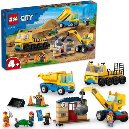 Pudełko zestawu LEGO 60391 City przedstawia scenę budowy z ciężarówkami i dźwigiem z kulą wyburzeniową, a na opakowaniu widnieje logo LEGO oraz oznaczenie wiekowe 4+. Na zdjęciu znajdują się także złożone modele pojazdów i budynków z zestawu oraz figurki 