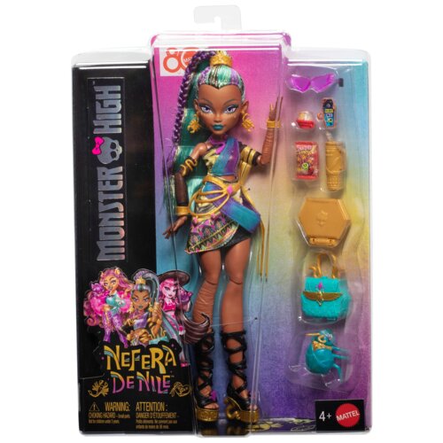 Opakowanie zawiera lalkę z serii Monster High o imieniu Nefera de Nile, ubraną w kolorowy strój z dodatkami, takimi jak złote bransoletki i turkusowa torebka. Na opakowaniu widnieje logo "Monster High" oraz napis "Nefera de Nile", a także ostrzeżenie o ma