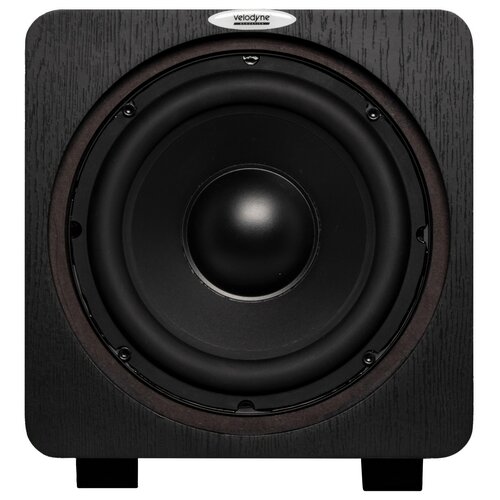 Czarny subwoofer z widocznym dużym głośnikiem na froncie, otoczony ciemnym drewnianym panelem. Na górze znajduje się logo z napisem "velodyne".