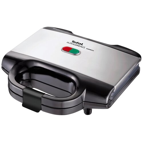 Srebrno-czarny opiekacz z napisem "Tefal ULTRACOMPACT SANDWICH" na górnej pokrywie, z dwoma wskaźnikami świetlnymi w kolorach czerwonym i zielonym. Urządzenie ma duży uchwyt z przodu.