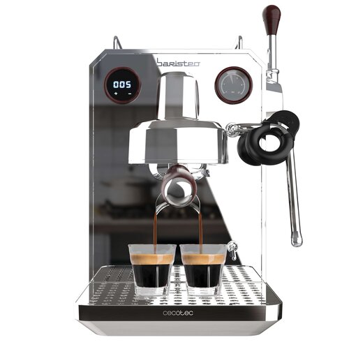 Ekspres do kawy Cecotec Baristeo Intima w kolorze srebrnym z wyświetlaczem pokazującym "005" oraz manometrem, przygotowuje dwa espresso do szklanek. Na obudowie widoczne są napisy "baristeo" i "cecotec".