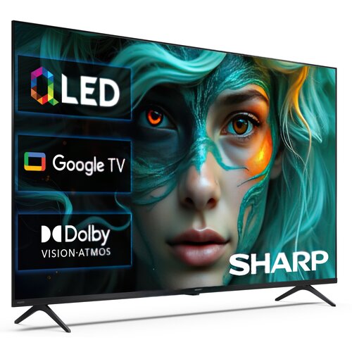 Telewizor z wyświetlaczem prezentującym kolorowy obraz twarzy z zielonymi i pomarańczowymi akcentami oraz teksty: "QLED", "Google TV", "Dolby Vision Atmos" i logo "SHARP".