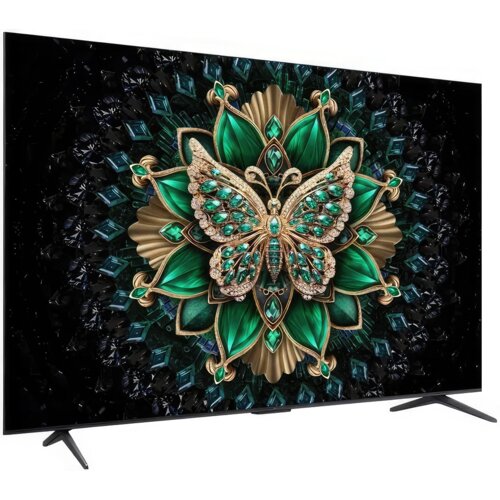 Telewizor wyświetla obraz przedstawiający ozdobnego motyla z zielonymi i złotymi elementami na tle skomplikowanego wzoru z liści i klejnotów. Ekran jest umieszczony na dwóch nóżkach, a ramka telewizora jest cienka.