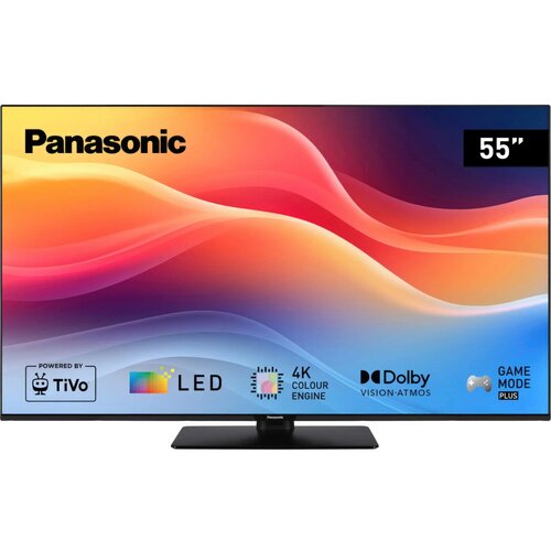 Telewizor marki Panasonic z ekranem o przekątnej 55 cali, wyświetlający kolorową grafikę z falistymi wzorami. Na ekranie widoczne są logotypy i napisy: "Powered by TiVo", "LED", "4K Colour Engine", "Dolby Vision-Atmos", "Game Mode Plus".