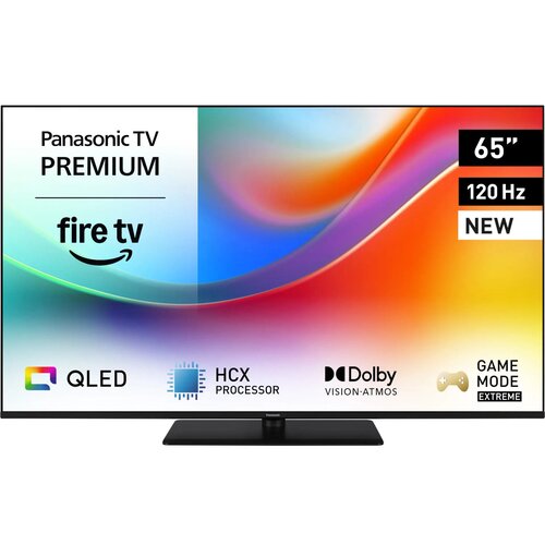 Telewizor z kolorowym ekranem wyświetla informacje: "Panasonic TV PREMIUM", "fire tv", "65”", "120 Hz", "NEW", oraz ikony i napisy: "QLED", "HCX PROCESSOR", "Dolby VISION·ATMOS", "GAME MODE EXTREME".