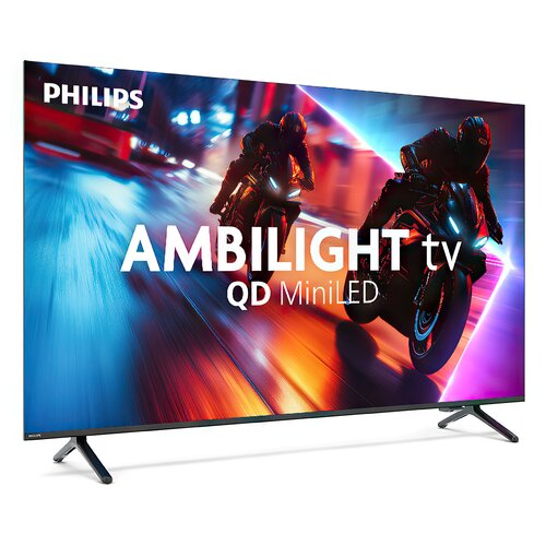 Na zdjęciu widoczny jest telewizor marki Philips z dynamiczną grafiką przedstawiającą dwóch motocyklistów na tle rozmytych świateł. Na ekranie znajduje się tekst: "PHILIPS AMBILIGHT tv QD MiniLED".