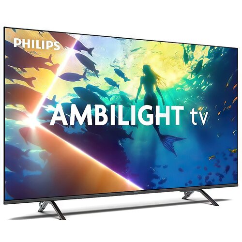 Telewizor z wyświetlaczem pokazującym kolorową scenę podwodną z sylwetką syreny i rybami, z widocznym tekstem "PHILIPS" oraz "AMBILIGHT tv". Urządzenie stoi na dwóch metalowych nóżkach.