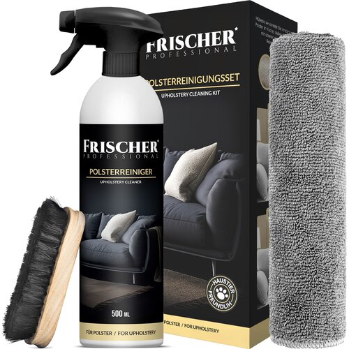 Na zdjęciu znajduje się zestaw czyszczący FRISCHER Professional, który obejmuje butelkę o pojemności 500 ml z napisem "POLSTERREINIGER UPHOLSTERY CLEANER", szczotkę z czarnym włosiem oraz szarą ściereczkę z mikrofibry. W tle widoczne jest opakowanie z gra