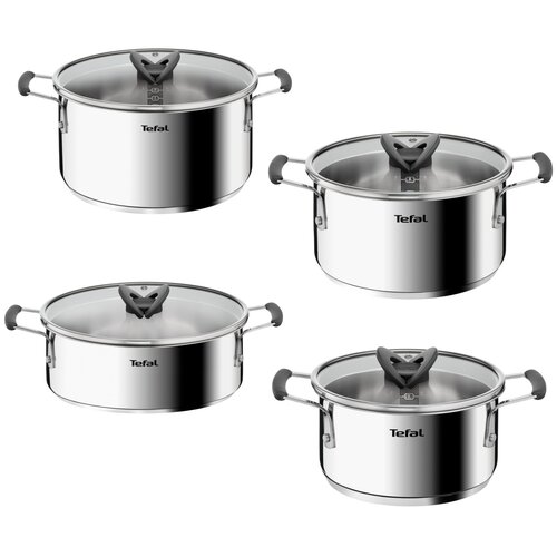 Na zdjęciu widoczny jest zestaw czterech stalowych garnków z przezroczystymi pokrywkami, każdy z uchwytami po bokach. Na każdym garnku znajduje się logo "Tefal".