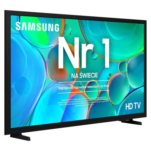 Telewizor z kolorowym ekranem wyświetla tekst: "SAMSUNG Nr 1 NA ŚWIECIE Najczęściej kupowane telewizory od 19 lat". W dolnej części ekranu znajduje się dodatkowy tekst informacyjny oraz oznaczenie "HD TV".