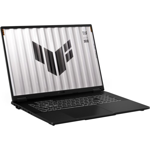 Czarny laptop z otwartym ekranem, na którym widoczny jest wzór złożony z ciemnych, geometrycznych kształtów na jasnym tle oraz tekst "TUF" i "TESTED FOR TOUGH". Klawiatura jest podświetlona, a na obudowie znajduje się logo producenta.