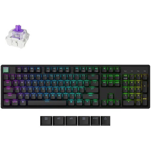 Na zdjęciu znajduje się klawiatura mechaniczna z podświetleniem RGB, z klawiszami oznaczonymi m.in. jako "esc", "shift", "ctrl", "alt", "enter" oraz klawiatura numeryczna. Obok klawiatury widoczny jest przełącznik mechaniczny oraz dodatkowe klawisze z ozn