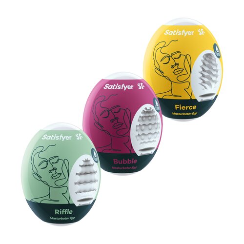 Trzy opakowania produktu "Satisfyer Eggs" w kolorach zielonym, różowym i żółtym, każde z grafiką twarzy i nazwami: Riffle, Bubble, Fierce. Na każdym opakowaniu widnieje napis "Satisfyer" oraz "Masturbator Egg".