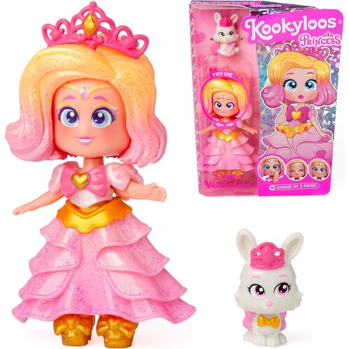 Lalka w różowej sukience z tiarą na głowie, obok opakowanie z napisem "Kookyloos Princess" oraz mała figurka białego królika z różowymi akcentami. Na opakowaniu widnieje napis "Princess Dream Wonderland" oraz "CHANGE MY 3 FACES!".