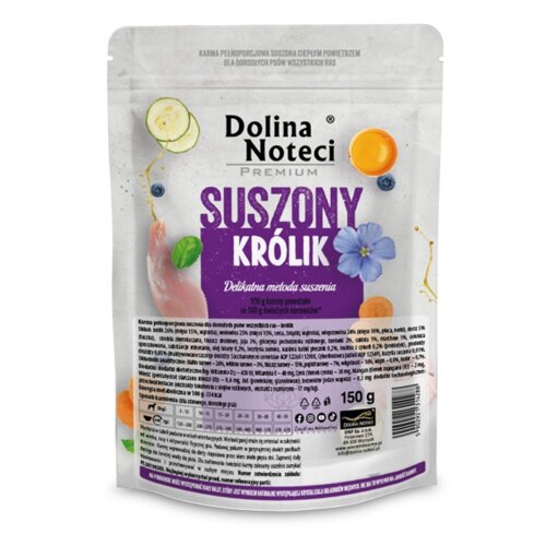 Opakowanie karmy dla psa "Dolina Noteci Premium Suszony Królik 150 g" z widocznymi grafikami warzyw i kwiatów oraz tekstem: "Delikatna metoda suszenia". Na dole opakowania znajdują się informacje o składzie, wartościach odżywczych i sposobie karmienia.