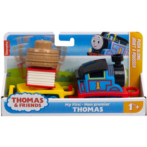 Opakowanie zabawki przedstawia kolorową lokomotywę z numerem "1" oraz wagonik z ładunkiem w postaci beczki i książek. Na opakowaniu widnieje logo "THOMAS & FRIENDS" oraz napisy "My First - Mon premier THOMAS" i "PUSH ALONG JOUET À POUSSER", a także oznacz