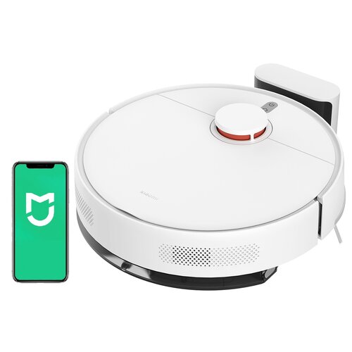Biały robot sprzątający z widocznym logo "Xiaomi" na górze, obok którego znajduje się smartfon z zielonym ekranem i białym logo w kształcie litery "M". Robot jest umieszczony na stacji dokującej.