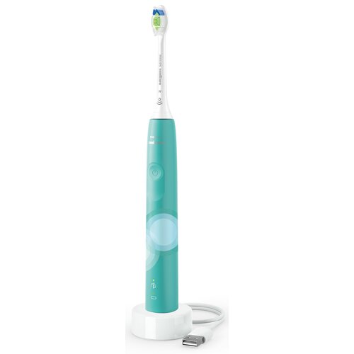 Zielona szczoteczka soniczna z białą główką, stojąca na białej podstawce z kablem USB. Na uchwycie widoczny jest przycisk zasilania oraz logo "Philips Sonicare".