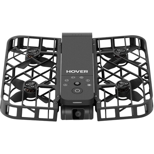 Czarny dron z widocznymi czterema śmigłami osłoniętymi kratką ochronną, na środku obudowy znajduje się napis "HOVER" oraz kilka przycisków i symboli. Na przedniej części drona umieszczona jest kamera.