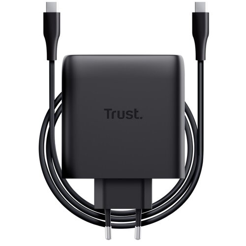 Czarny zasilacz do laptopa z widocznym logo "Trust" na obudowie, z dwoma przewodami zakończonymi wtyczkami. Produkt ma kompaktowy design i jest przeznaczony do ładowania urządzeń.