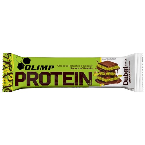 Opakowanie batona proteinowego z napisem "OLIMP PROTEIN bar" oraz "Choco & Pistachio & Kadayif Source of Protein" na zielonym tle. Po prawej stronie widnieje napis "Dubai STYLE CHOCOLATE FLAVOUR" oraz ilustracja przekrojonego batona z warstwami czekolady 