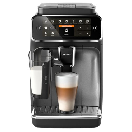 Ekspres do kawy z wyświetlaczem dotykowym, na którym widoczne są ikony różnych rodzajów kaw, takich jak espresso, cappuccino i latte macchiato, oraz napis "Enjoy!". Na ekspresie znajduje się logo "PHILIPS", a obok widać szklankę z przygotowanym latte macc
