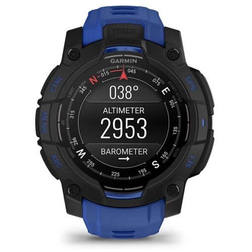 Czarny smartwatch z niebieskim paskiem wyświetla na ekranie informacje: "038°", "ALTIMETER 2953", "BAROMETER", a wokół tarczy znajdują się oznaczenia kierunków i przyciski z napisami "MENU", "CTRL", "ABC", "GPS", "SET". Na górze widoczne jest logo "GARMIN