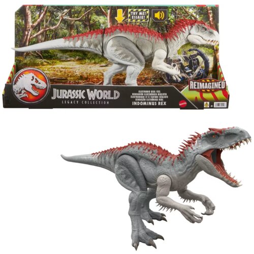 Na zdjęciu znajduje się figurka dinozaura Indominus Rex z kolekcji Jurassic World Legacy, umieszczona na tle opakowania z grafiką lasu. Na opakowaniu widnieje logo Jurassic World oraz napisy: "TRY ME! ESSAIE!", "REIMAGINED", "ELECTRONIC REAL FEEL", "INDOM